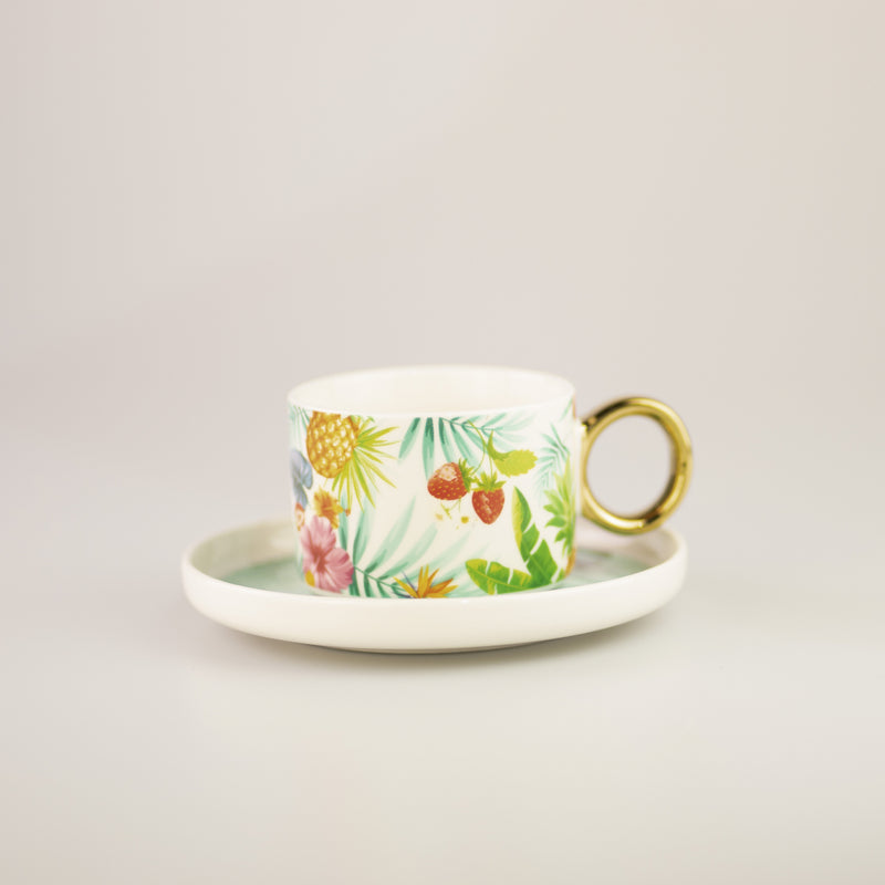 Tazza in ceramica con disegno tropicale e manico in oro, con piattino